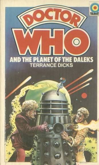 The cover of the novelisation Doctor Who and the Planet of the Daleks by Terrance Dicks. Against the background of a massive planet and comets in the sky, the Doctor and Taron stand on either side of a Dalek, the Doctor holding its sink plunger and Taron holding the gun, from which a death ray is emitted.